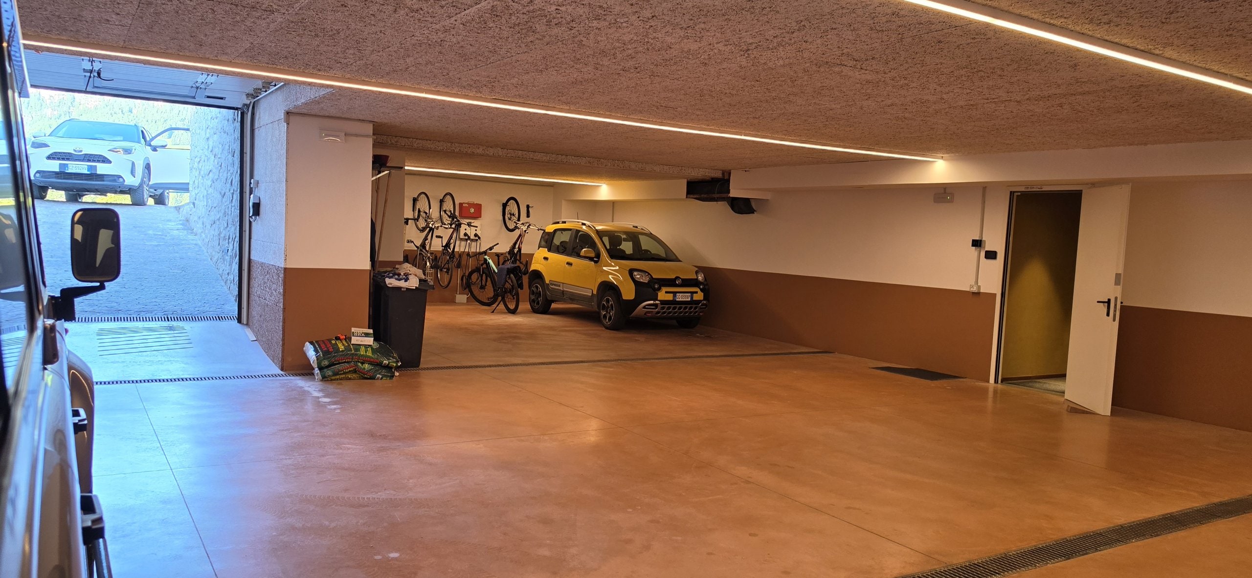 Garage interior with the door open to the road and the internal door giving direct access to the house