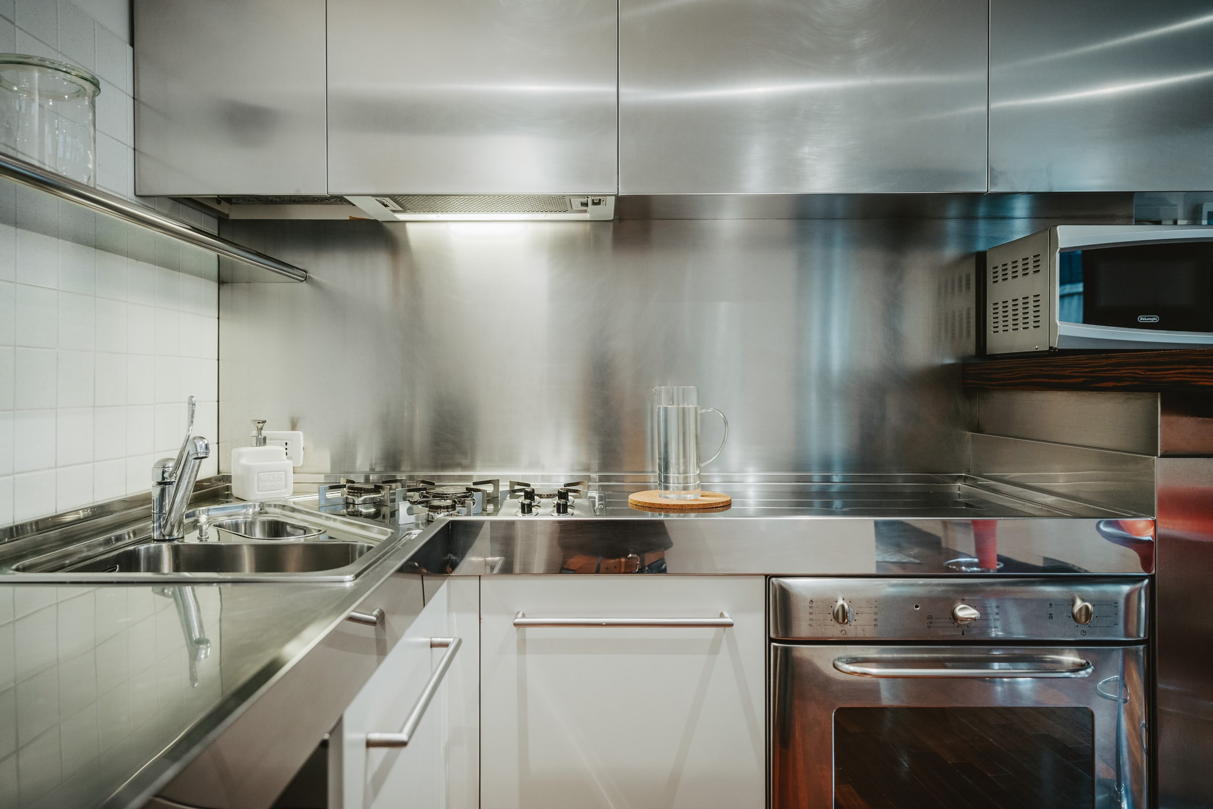 Dettaglio cucina: acciaio, piano cottura a gas professionale